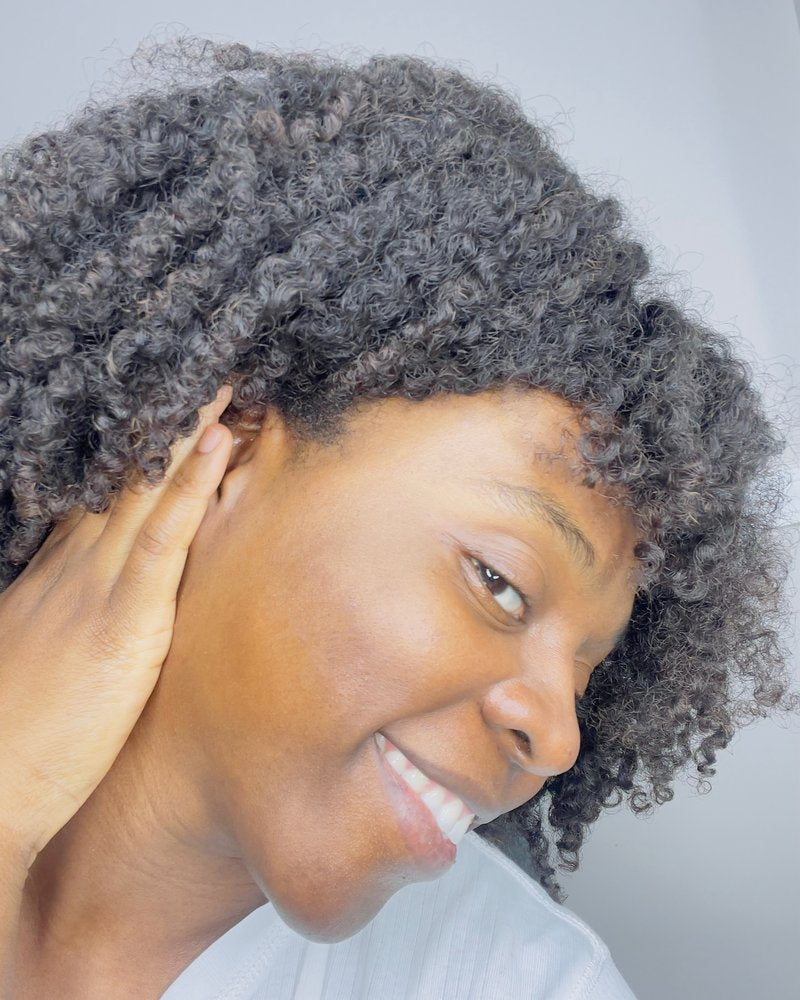 Nadege today, smiling, with clear-looking, glowing skin